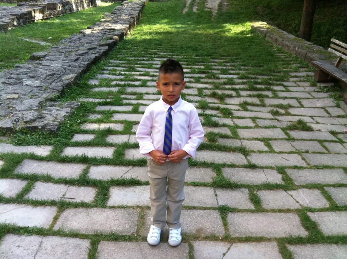 Ádám Péter as a small child, wearing white shoes