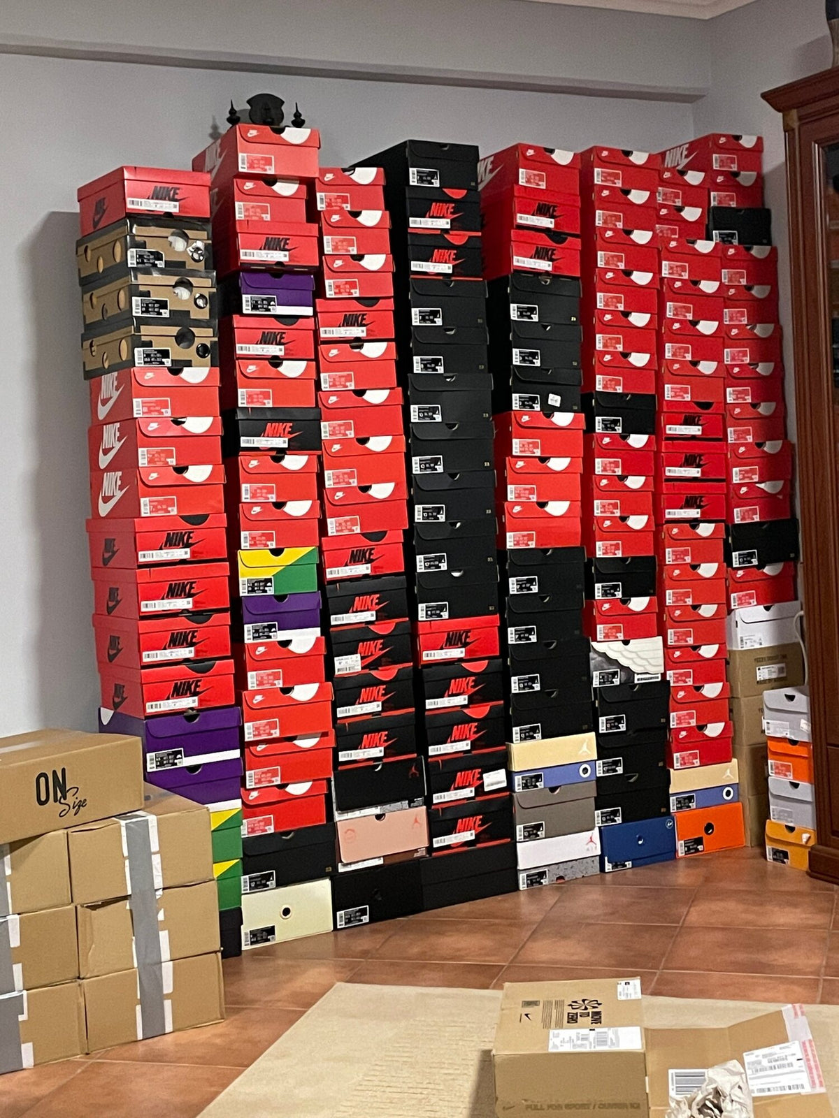 Ceiling-high columns of sneaker boxes in the corner of a room