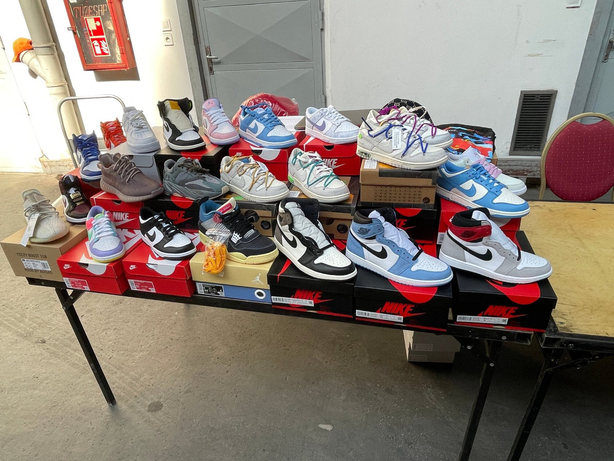 Sneakers on their boxes on a table at a sneaker event