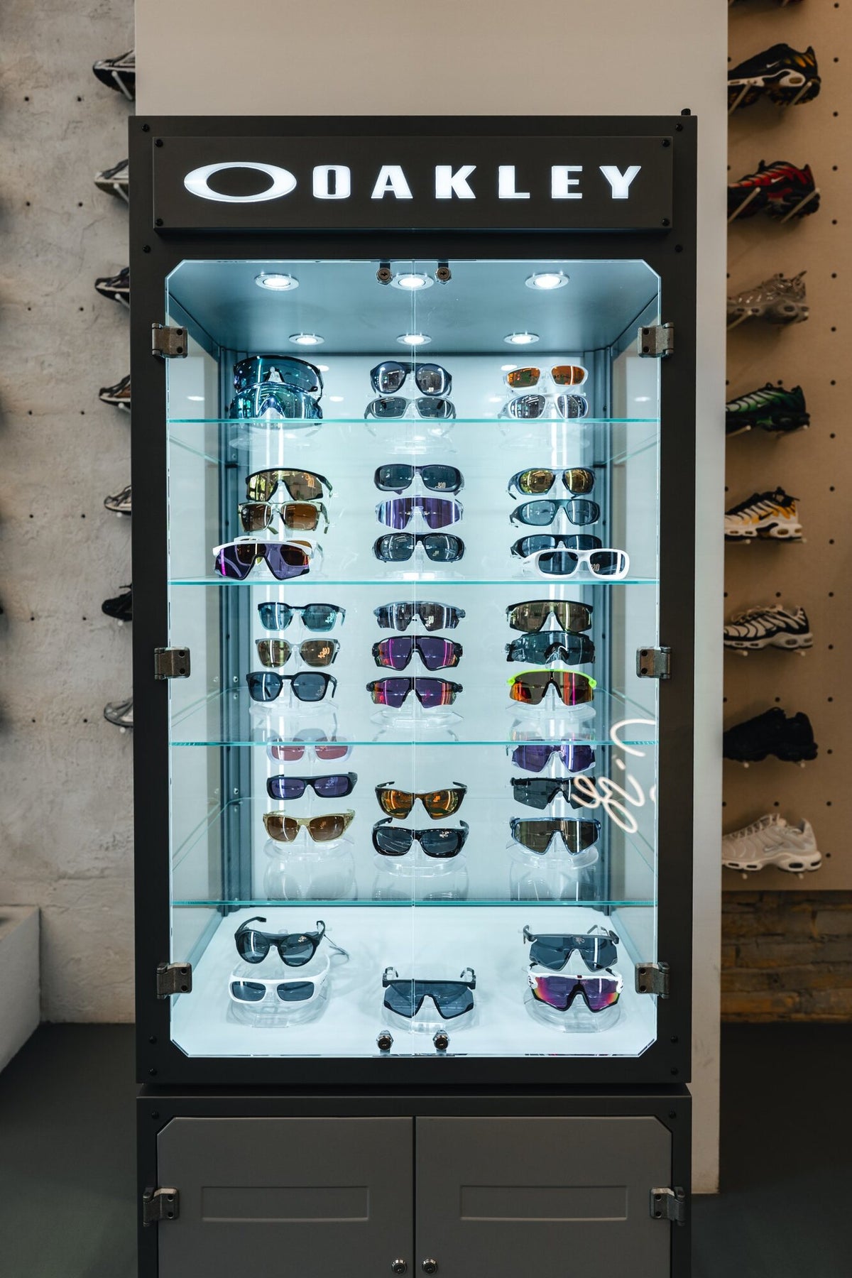 An illuminated Oakley sunglasses display case