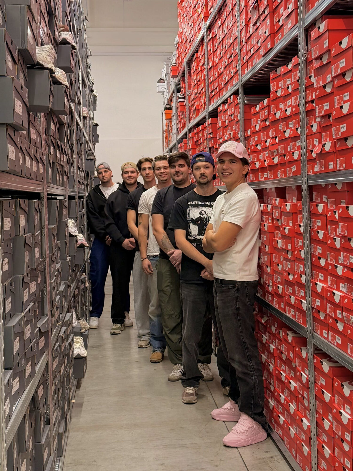 Warehouse staff lined up between shelves full of boxes
